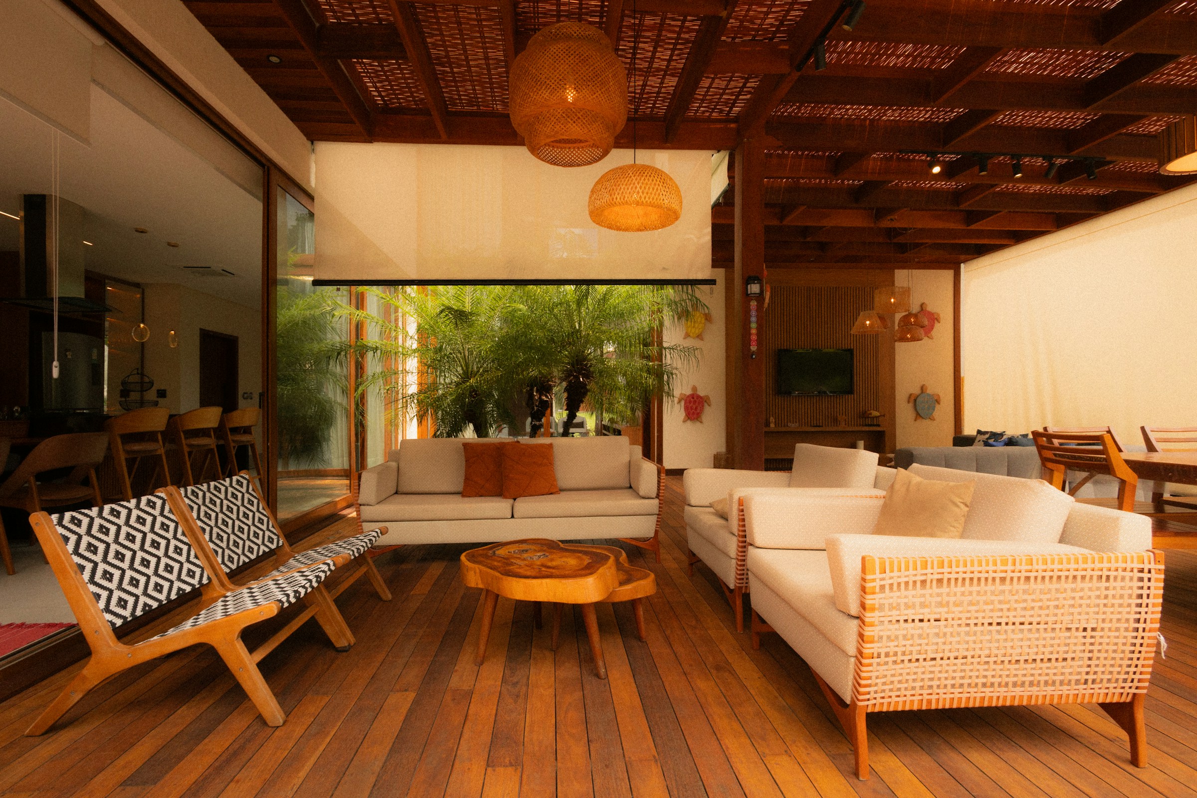 A light-filled living room with natural materials, neutral sofas and warm wooden furniture